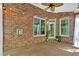 Cozy covered patio with brick walls and view to the wooded backyard at 5407 Waters Edge Trl, Roswell, GA 30075