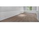 Bright room features neutral walls, carpeted floor, base molding, and a window at 5407 Waters Edge Trl, Roswell, GA 30075
