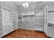 Expansive walk-in closet with custom shelving and hardwood floors at 5407 Waters Edge Trl, Roswell, GA 30075