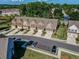 Community aerial view highlights well-maintained townhomes with attached garages and manicured green spaces at 1216 Foxcroft Ln, Cumming, GA 30041