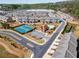 Overhead view displays the community with tennis courts, a pool, and well-maintained townhomes, fostering a vibrant neighborhood at 1216 Foxcroft Ln, Cumming, GA 30041