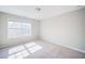 Bright and spacious bedroom with large window, neutral carpet, and smooth, freshly-painted walls at 1216 Foxcroft Ln, Cumming, GA 30041