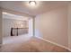 Carpeted bedroom with view of hallway landing and decorative lighting at 1216 Foxcroft Ln, Cumming, GA 30041