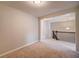 Bedroom with neutral walls, plush carpet, and view of the landing with decorative lighting at 1216 Foxcroft Ln, Cumming, GA 30041