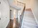 Welcoming foyer with hardwood floors, staircase, and a view into the kitchen at 1216 Foxcroft Ln, Cumming, GA 30041
