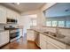 Open kitchen featuring stainless steel appliances, granite countertops, and wooden floors at 1216 Foxcroft Ln, Cumming, GA 30041