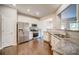 Modern kitchen with stainless steel appliances, granite countertops, and wooden floors at 1216 Foxcroft Ln, Cumming, GA 30041