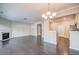 Bright living room with fireplace and dark hardwood floors and an elegant chandelier at 1216 Foxcroft Ln, Cumming, GA 30041