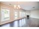 A light filled living room boasts hardwood floors and a fireplace, with backyard access at 1216 Foxcroft Ln, Cumming, GA 30041