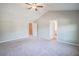 Large main bedroom featuring plush carpet and multiple windows for natural light at 1216 Foxcroft Ln, Cumming, GA 30041
