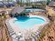 Aerial view of the community pool and clubhouse with abundant seating for relaxation and socializing at 1216 Foxcroft Ln, Cumming, GA 30041