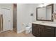 Bathroom featuring wood tile floors, a glass shower, and granite counters at 1811 Kent Ave, Dunwoody, GA 30338