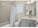 Bathroom featuring neutral tile, shower-tub combo and a large mirror at 1811 Kent Ave, Dunwoody, GA 30338