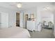 Bright bedroom with a cozy bed, white dresser, and a charming study nook, perfect for relaxation and creativity at 1811 Kent Ave, Dunwoody, GA 30338