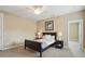 Comfortable bedroom features a dark bed frame and neutral carpet at 1811 Kent Ave, Dunwoody, GA 30338
