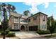 Charming brick home showcasing lush landscaping, large garage, and a well-maintained front yard at 1811 Kent Ave, Dunwoody, GA 30338
