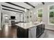 Contemporary kitchen with island, stainless appliances, sleek cabinets, and open concept living space at 1811 Kent Ave, Dunwoody, GA 30338