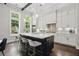 Kitchen featuring white cabinets, stainless appliances, an island with seating, and plenty of natural light at 1811 Kent Ave, Dunwoody, GA 30338