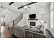 Spacious living room with hardwood floors, fireplace, staircase, and stylish furnishings at 1811 Kent Ave, Dunwoody, GA 30338