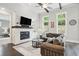 Bright living room with a stone fireplace, hardwood floors, comfortable seating, and abundant natural light at 1811 Kent Ave, Dunwoody, GA 30338
