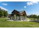 Open-air pavilion in a park setting, featuring stone pillars, benches, and a decorative metal roof at 1811 Kent Ave, Dunwoody, GA 30338