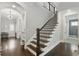 A staircase with dark wood steps and iron railings, showcasing the home's entryway and modern design elements at 1811 Kent Ave, Dunwoody, GA 30338