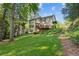 Expansive backyard with a deck, lush greenery, and mature trees creating a private oasis at 1880 Barrett Dr, Cumming, GA 30040