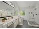 Bathroom with a double vanity, soaking tub, and walk-in shower at 1880 Barrett Dr, Cumming, GA 30040