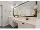Bathroom with a double vanity, modern lighting, and lots of mirror space at 1880 Barrett Dr, Cumming, GA 30040