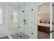 Modern bathroom showcasing the walk-in shower with white tile and stone flooring at 1880 Barrett Dr, Cumming, GA 30040