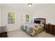 Inviting carpeted bedroom with two windows providing lots of natural light at 1880 Barrett Dr, Cumming, GA 30040