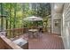 Enjoy outdoor living on this spacious deck with an umbrella table, seating, and a grill at 1880 Barrett Dr, Cumming, GA 30040