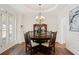 Bright dining room featuring hardwood floors, a round table, and a china cabinet at 1880 Barrett Dr, Cumming, GA 30040