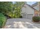 Spacious driveway leading to a two-car garage, surrounded by lush landscaping at 1880 Barrett Dr, Cumming, GA 30040