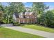 Beautiful two-story brick home with manicured lawn and a long driveway at 1880 Barrett Dr, Cumming, GA 30040