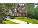 Traditional brick home boasting a manicured lawn and charming front porch at 1880 Barrett Dr, Cumming, GA 30040