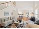 Open-concept living room featuring hardwood floors, and seamless flow to kitchen and dining area at 1880 Barrett Dr, Cumming, GA 30040