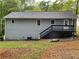 The back exterior view showcases a deck with a staircase and a well-kept lawn at 214 Sweetwater Cir, Powder Springs, GA 30127