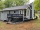 View of the home's rear exterior featuring a deck and bay window at 214 Sweetwater Cir, Powder Springs, GA 30127