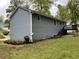 Home's rear exterior featuring a deck, garden area, and well-maintained lawn at 214 Sweetwater Cir, Powder Springs, GA 30127