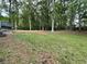 Spacious backyard with mature trees, offering privacy and ample space for recreation at 214 Sweetwater Cir, Powder Springs, GA 30127