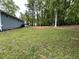 Expansive backyard bordered by lush trees, providing a serene and private outdoor space at 214 Sweetwater Cir, Powder Springs, GA 30127