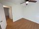 Open view of a light-filled bedroom highlighting trim, hardwood floors, and a modern ceiling fan at 214 Sweetwater Cir, Powder Springs, GA 30127