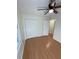Sunlit bedroom featuring hardwood floors, a double door closet, and a modern ceiling fan at 214 Sweetwater Cir, Powder Springs, GA 30127