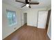 Well-lit bedroom featuring a ceiling fan, light-colored walls with trim, and a window overlooking the outdoors at 214 Sweetwater Cir, Powder Springs, GA 30127