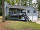 Charming two-story home with a welcoming front porch and well-maintained landscaping at 214 Sweetwater Cir, Powder Springs, GA 30127