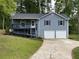 Charming two-story home featuring a two-car garage, front porch, and landscaped yard at 214 Sweetwater Cir, Powder Springs, GA 30127