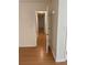 Bright hallway with neutral walls and hardwood flooring extending into adjoining rooms at 214 Sweetwater Cir, Powder Springs, GA 30127