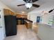 Kitchen with oak cabinets, black appliances, and open breakfast bar connects seamlessly to the living area at 214 Sweetwater Cir, Powder Springs, GA 30127
