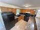 Kitchen featuring oak cabinets, sleek black appliances, and a breakfast bar, perfect for casual dining at 214 Sweetwater Cir, Powder Springs, GA 30127